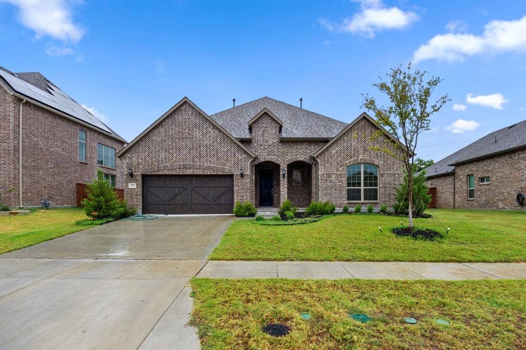 16050 Talamore Lane, Frisco, TX 75035 Megatel 1.5 story house with a front yard and a garage