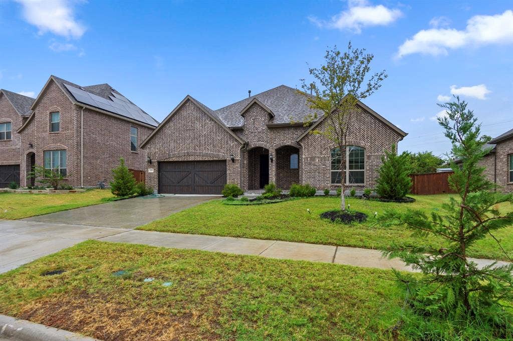 16050 Talamore Lane, Frisco, TX 75035 French country home featuring a front yard and a garage