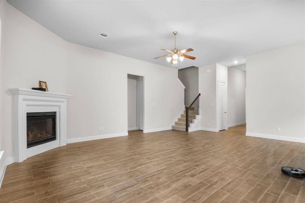 16050 Talamore Lane, Frisco, TX 75035 Unfurnished living room with ceiling fan and light wood-type flooring