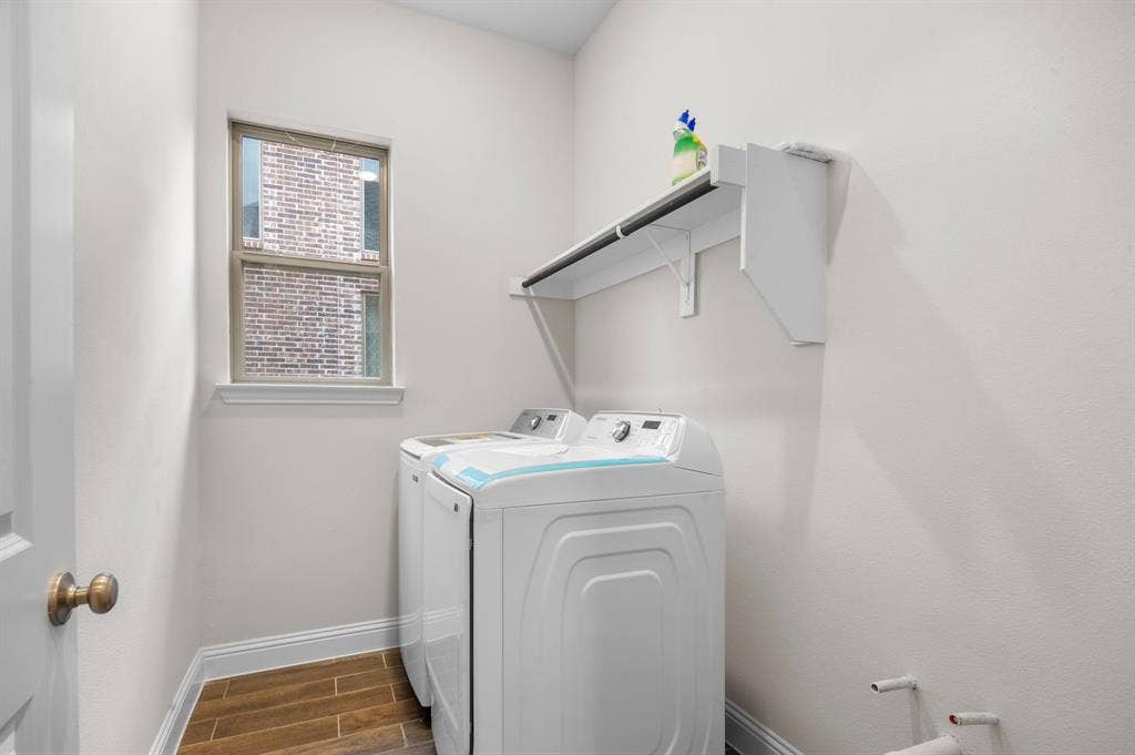 16050 Talamore Lane, Frisco, TX 75035 Washroom featuring dark hardwood / wood-style floors and separate washer and dryer