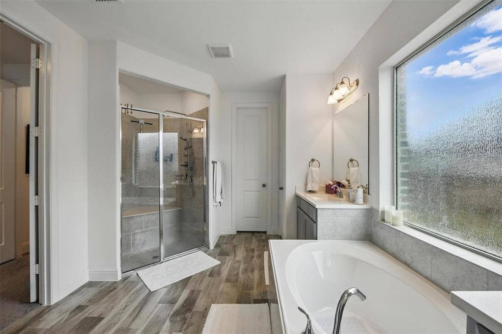1477 Shooting Star Drive, Haslet, TX 76052 With garden tub, walk-in shower, and separate vanities.