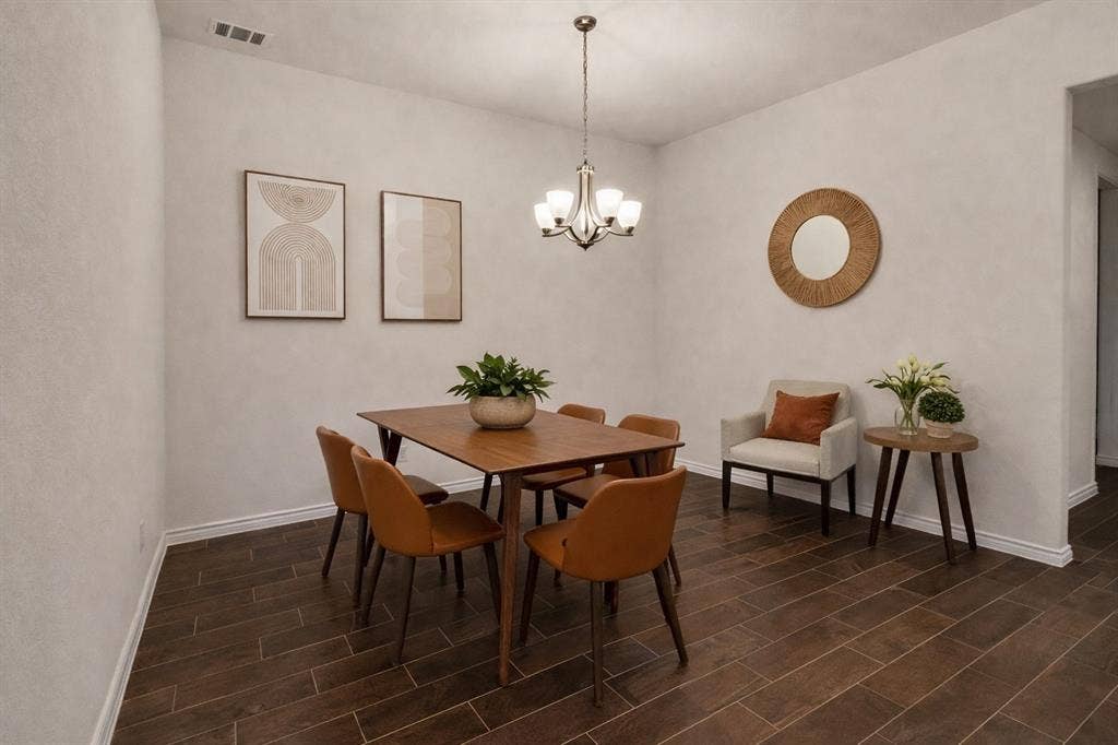 3106 Maverick Drive, Heath, TX 75126 Dining area featuring wood-finish flooring, white baseboards, and a chandelier light fixture