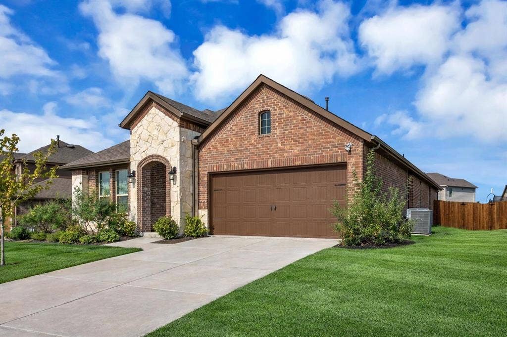 3106 Maverick Drive, Heath, TX 75126 Brick and stone exterior featuring an arched entryway
