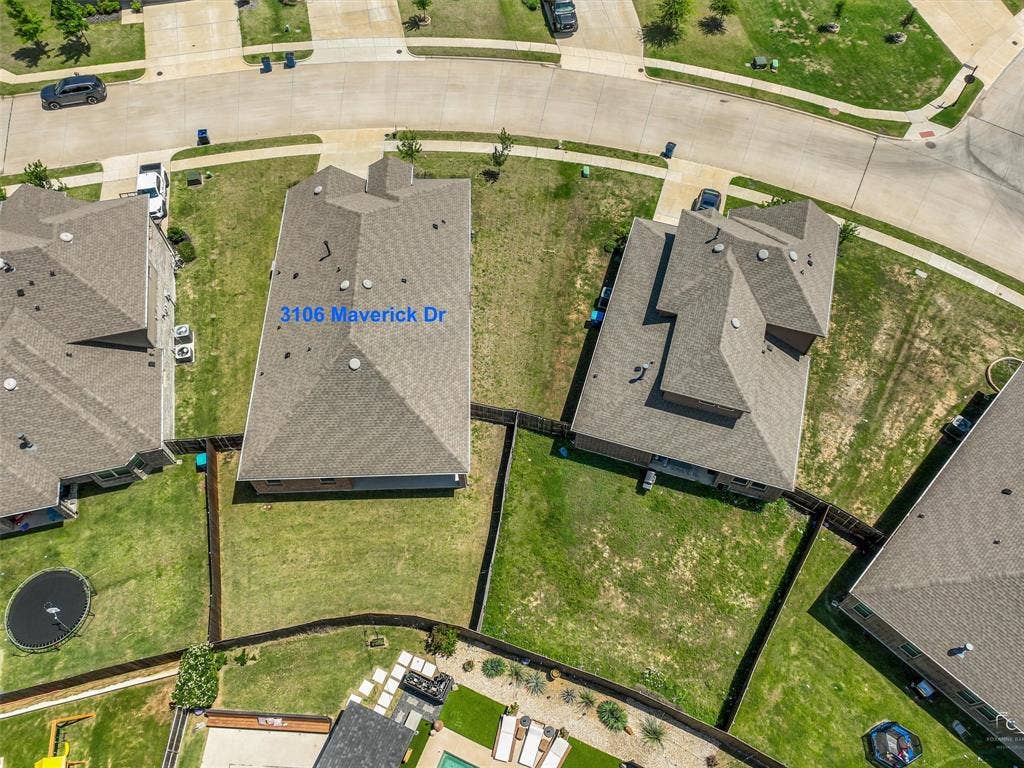 3106 Maverick Drive, Heath, TX 75126 Single-story residence with a gray shingle roof and a private fenced backyard