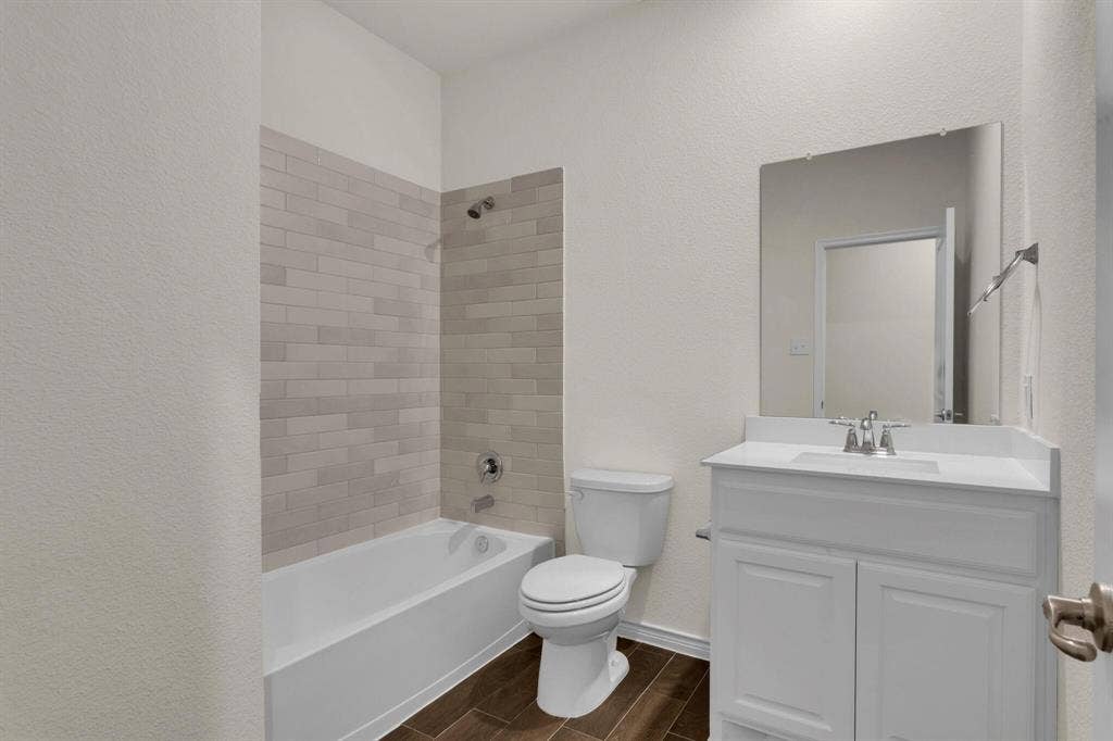3106 Maverick Drive, Heath, TX 75126 Bathroom featuring a white vanity with a single sink, an integrated white countertop, and a large wall-mounted mirror