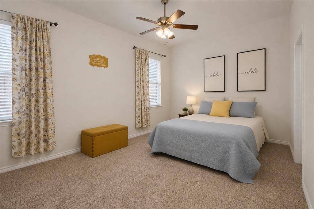 3106 Maverick Drive, Heath, TX 75126 Carpeted bedroom featuring two windows with blinds, a ceiling fan with integrated lighting, and a neutral color palette