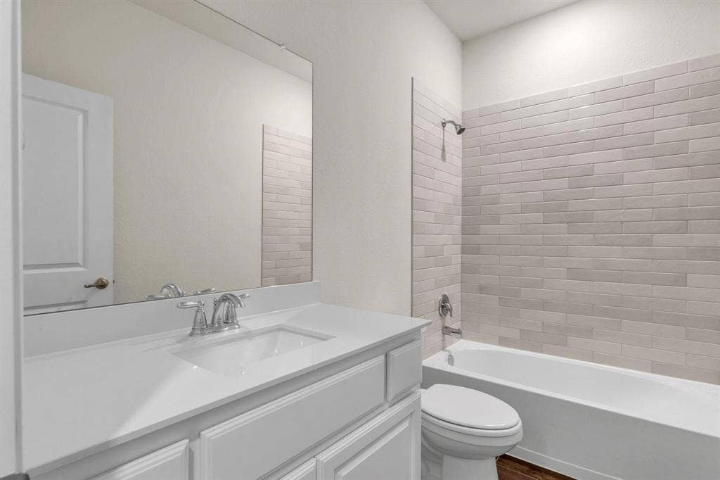 3106 Maverick Drive, Heath, TX 75126 Bathroom featuring a white vanity with an integrated sink, polished chrome faucet, and a large wall-mounted mirror