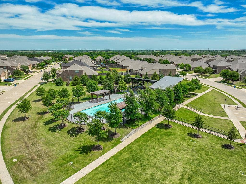 3106 Maverick Drive, Heath, TX 75126 Community pool and recreation area featuring a covered patio, paved walkways, and extensive green spaces