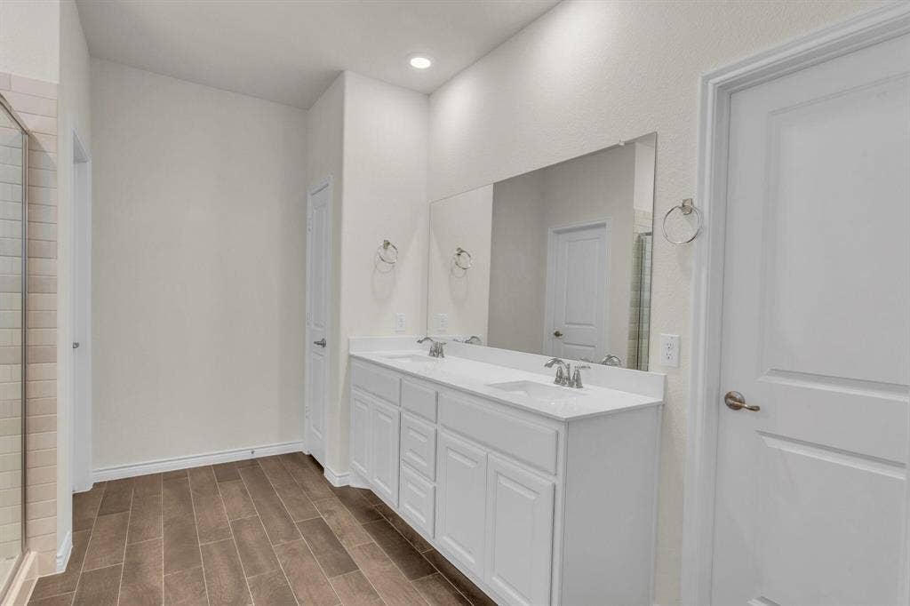 3106 Maverick Drive, Heath, TX 75126 Bathroom featuring a dual vanity with white cabinetry, integrated sinks, and a large wall-mounted mirror