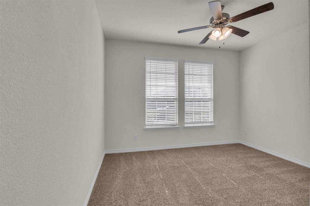 3106 Maverick Drive, Heath, TX 75126 Bedroom featuring two windows with white blinds, neutral carpeting, light-toned walls, and a ceiling fan with integrated lighting