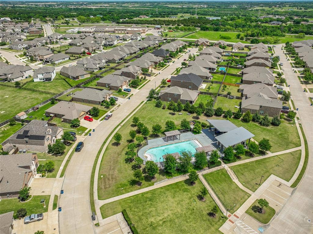 3106 Maverick Drive, Heath, TX 75126 Community amenities featuring a swimming pool with surrounding deck, an open-air pavilion, and extensive green spaces
