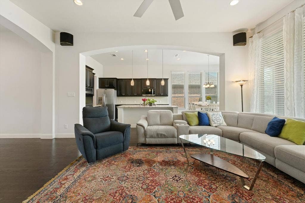 1113 5th Street, Argyle, TX 76226 Open-concept living room and kitchen with engineered hardwood floors, high ceilings, large windows and flexible space for everyday living.