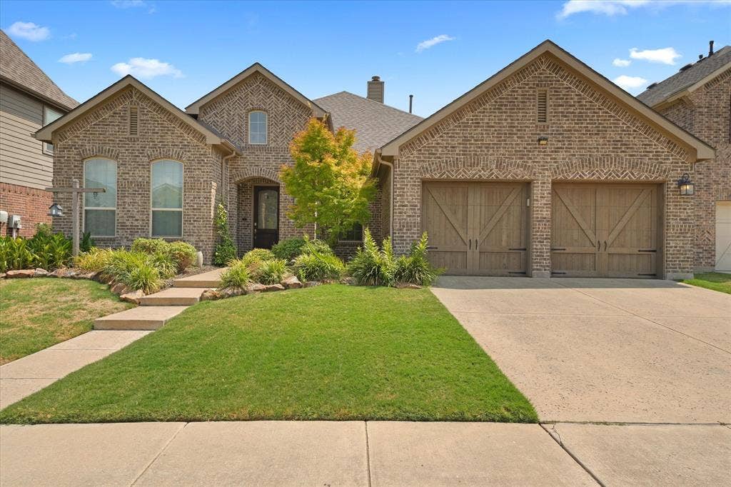 1113 5th Street, Argyle, TX 76226 Front view of the 3-bedroom, 2-bath home with established landscaping, traditional brick architecture and a single-story floor plan in Argyle ISD.