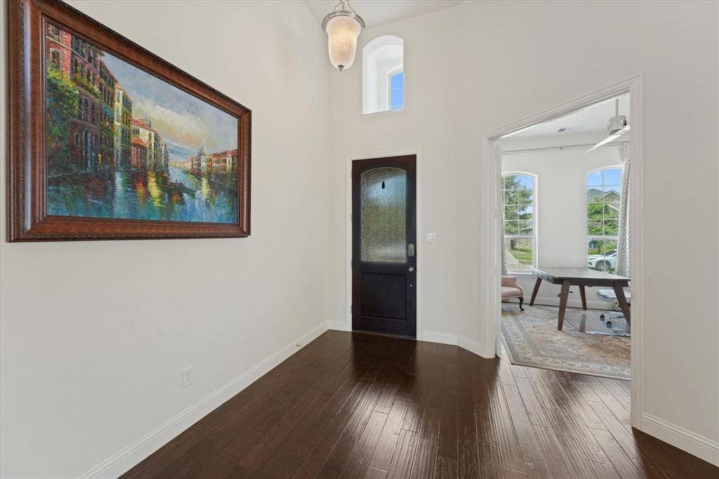 1113 5th Street, Argyle, TX 76226 Bright entry with high ceilings, engineered hardwood flooring and direct access to the private home office near the front of the house.