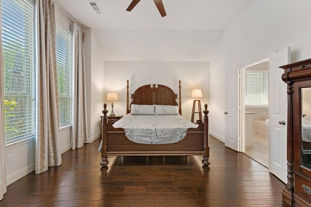 1113 5th Street, Argyle, TX 76226 Spacious primary suite with vaulted ceilings, engineered hardwood flooring, large windows and direct access to the ensuite bath.