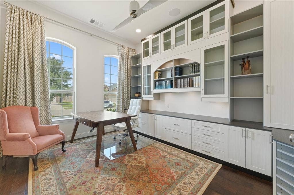 1113 5th Street, Argyle, TX 76226 Private study with large windows, abundant natural light and extensive built-in cabinets, shelving and workspace for a home office.