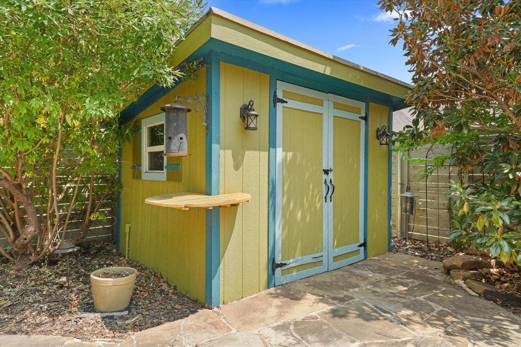 1113 5th Street, Argyle, TX 76226 Detached storage building with electricity, workshop space and additional storage for tools, hobbies or lawn equipment.