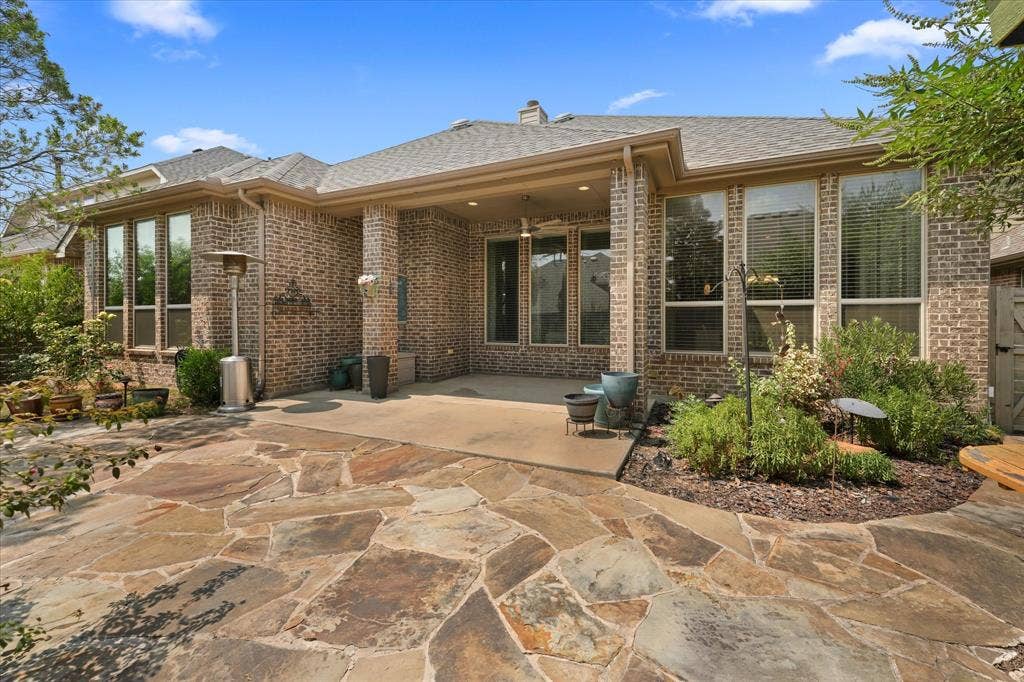 1113 5th Street, Argyle, TX 76226 Covered back patio with ceiling fan and recessed lighting, offering a comfortable outdoor living space overlooking the landscaped backyard.