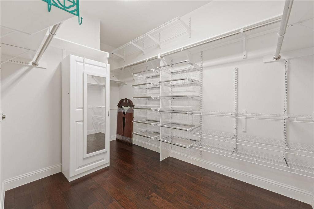 1113 5th Street, Argyle, TX 76226 Large walk-in closet with custom organization system, built-in drawers, shelving and abundant hanging space.