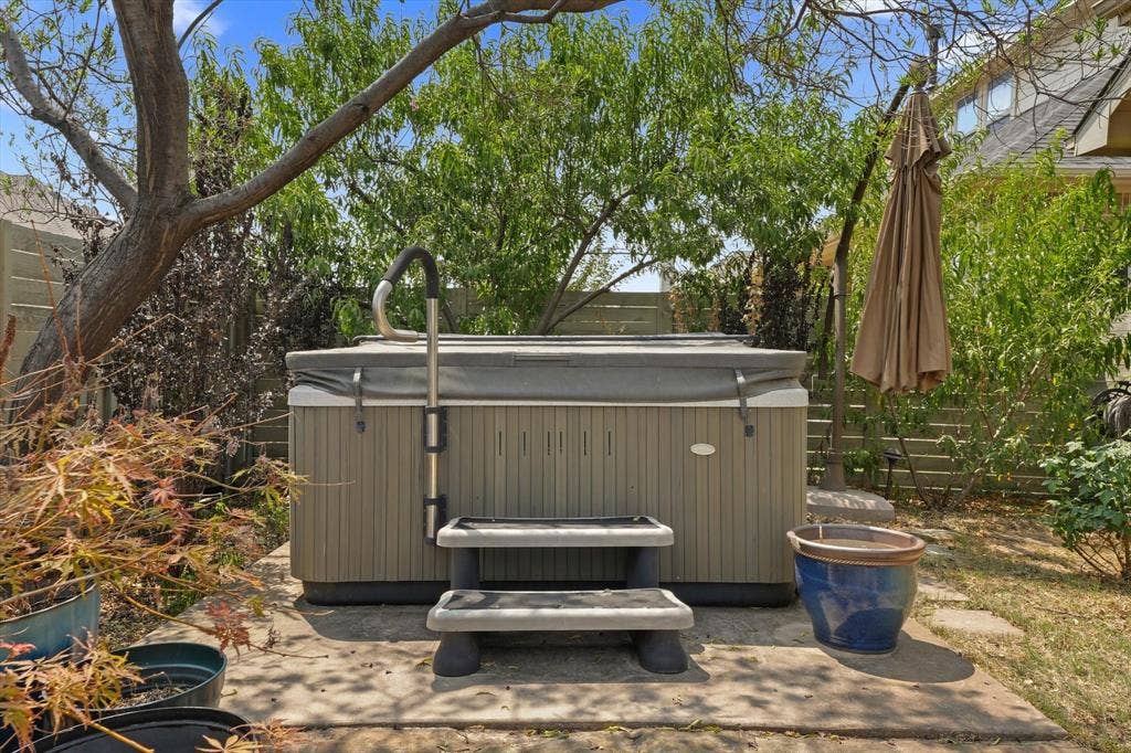 1113 5th Street, Argyle, TX 76226 Private hot tub nestled among mature landscaping, creating a peaceful outdoor retreat to relax and unwind at the end of the day.