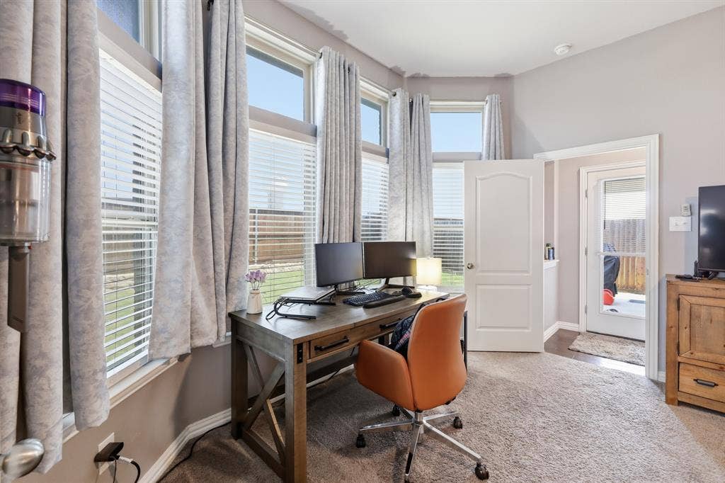 1556 Seminole Drive, Forney, TX 75126 Primary bedroom is large enough to have a small office area set up on the recessed window area