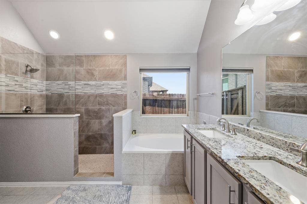 1556 Seminole Drive, Forney, TX 75126 Primary bathroom is spacious and beautiful, dual sinks on large granite countertop. large walk in shower