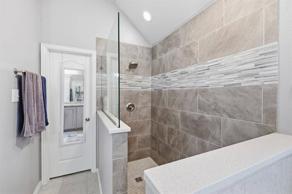 1556 Seminole Drive, Forney, TX 75126 Walk-in shower featuring a frameless glass panel