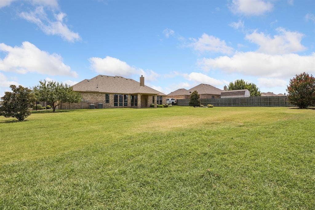 Impressive backyard featuring a generous covered patio, mature landscaping, and an expansive lawn offering endless possibilities for recreation and entertaining. This home sits on .6 acres!