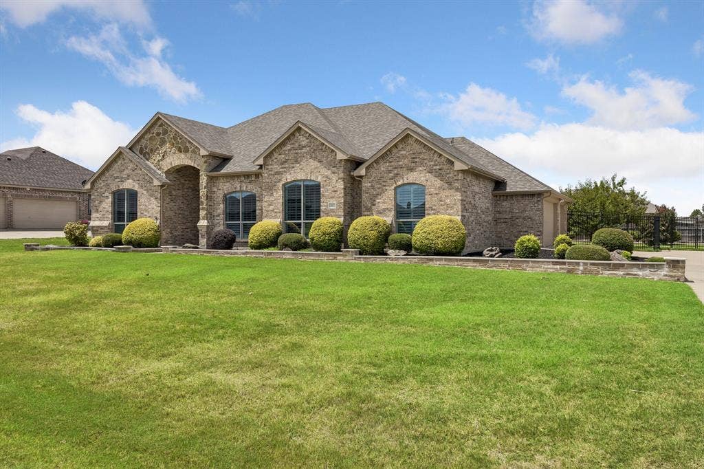 The expansive lot showcases the home's impressive architecture, oversized yard, and meticulously maintained exterior.
