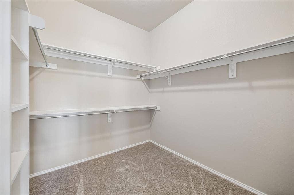 An enormous primary walk-in closet with built-in shelving and abundant hanging space keeps everything organized with ease.