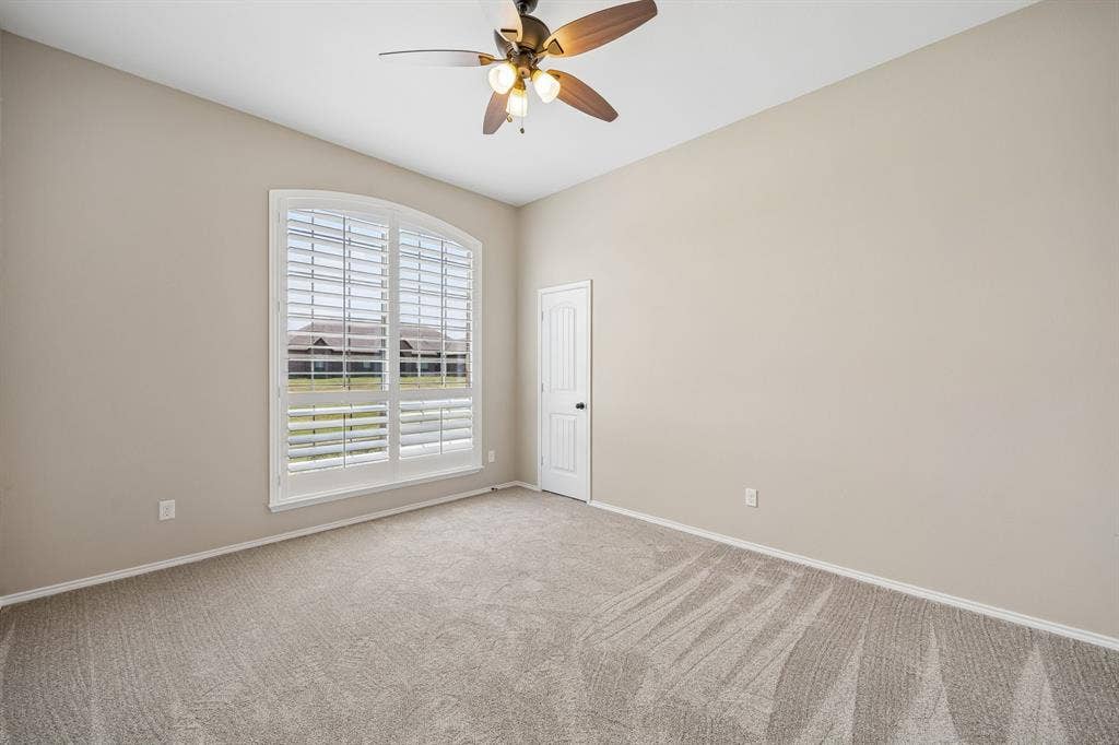 French doors open to a versatile flex space that makes an ideal home office, 4th bedroom, formal living room, playroom, or study.