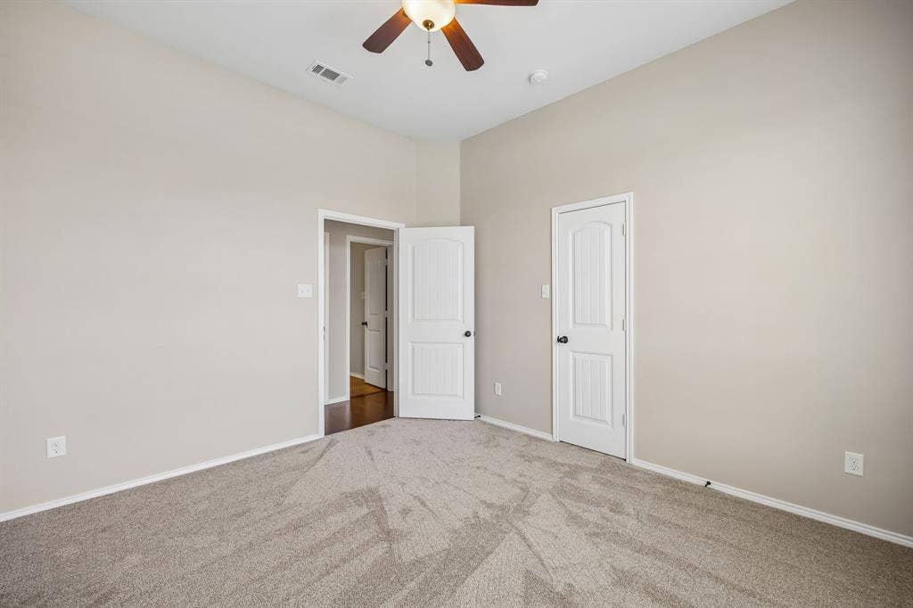 Another view of the secondary bedroom. Generous proportions provide flexibility for any lifestyle while the neutral palette makes decorating effortless.