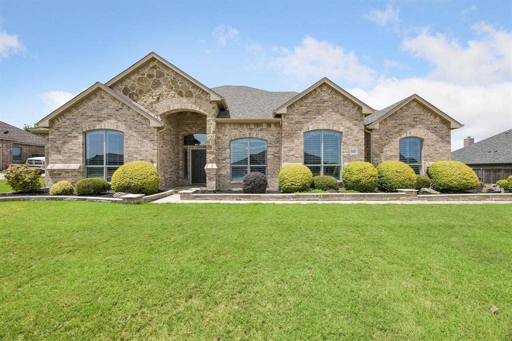 Welcome home! This beautiful brick and stone home with manicured landscaping, mature shrubs, and exceptional curb appeal create a warm first impression for your guests.