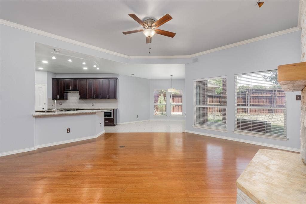1913 Abilene Way, McKinney, TX 75072 Living area featuring wood-finish flooring, a ceiling fan, and multiple windows