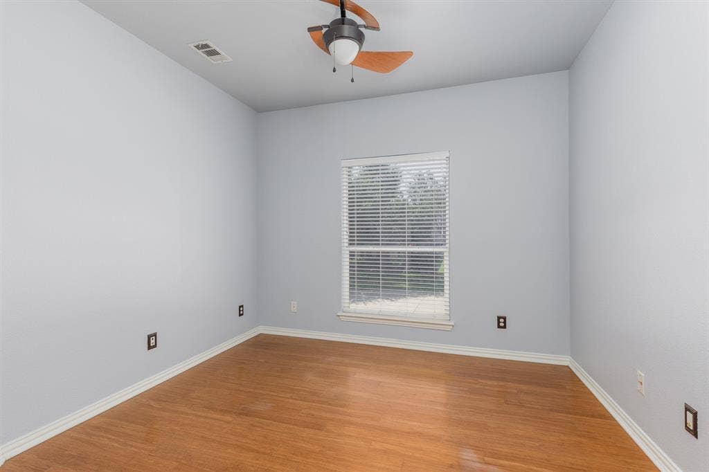 1913 Abilene Way, McKinney, TX 75072 Room featuring wood-finish flooring, light gray walls, white baseboards, and a window with blinds