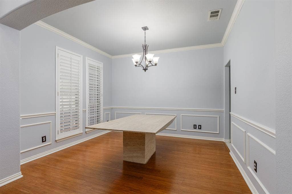 1913 Abilene Way, McKinney, TX 75072 Spacious room featuring wood-finish flooring and a decorative chandelier