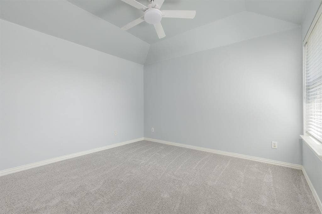 1913 Abilene Way, McKinney, TX 75072 Vaulted ceiling with a ceiling fan, light gray wall paint, white trim, gray carpet, and a window with blinds