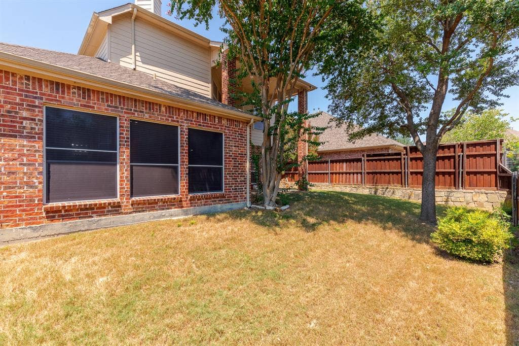 1913 Abilene Way, McKinney, TX 75072 Brick exterior with multiple windows featuring dark screens