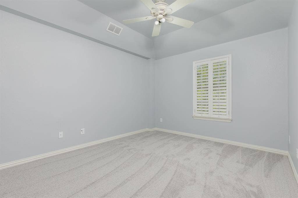 1913 Abilene Way, McKinney, TX 75072 Neutral-toned carpeting and light blue walls define this room, featuring a tray ceiling with a ceiling fan