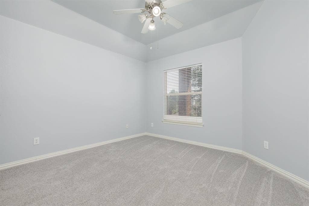 1913 Abilene Way, McKinney, TX 75072 Bedroom featuring vaulted ceilings, light gray wall paint, light gray carpet flooring, a window with horizontal blinds, and a ceiling fan with integrated lighting