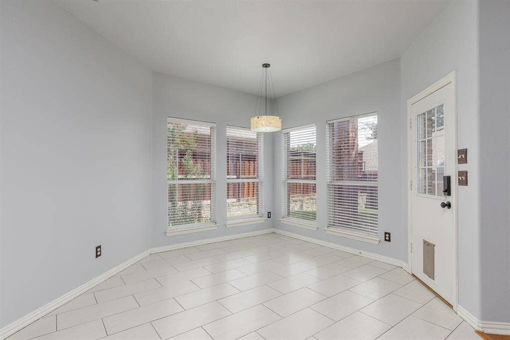 1913 Abilene Way, McKinney, TX 75072 Bright corner room featuring expansive multi-pane windows with plantation shutters, ceramic tile flooring, and a pendant light fixture