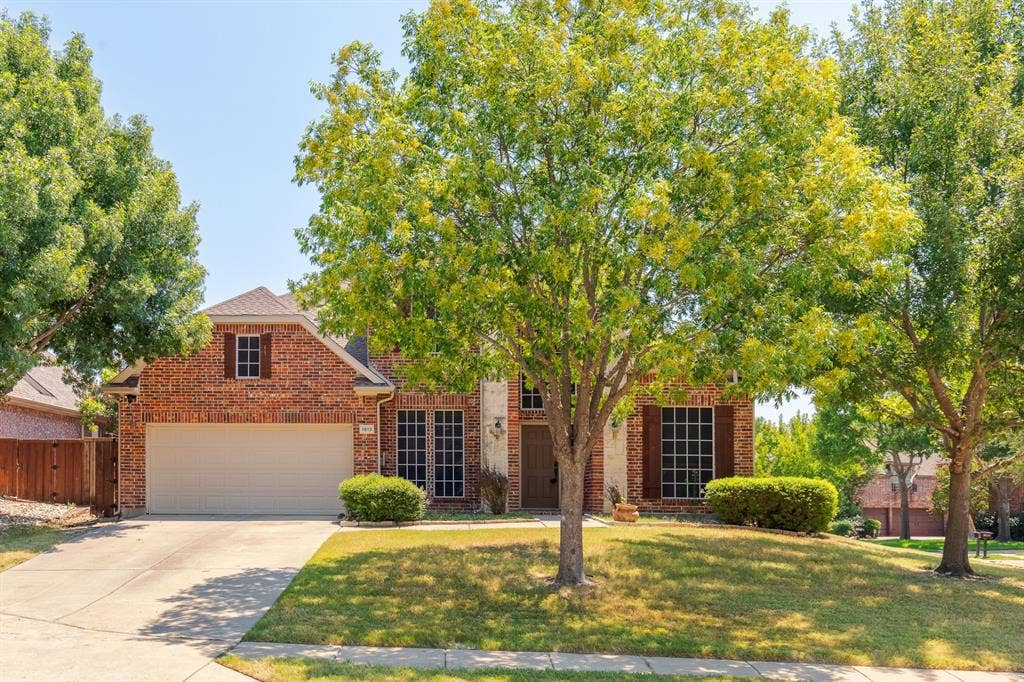 1913 Abilene Way, McKinney, TX 75072 Brick two-story residence featuring a two-car garage, mature front yard trees, and a concrete driveway