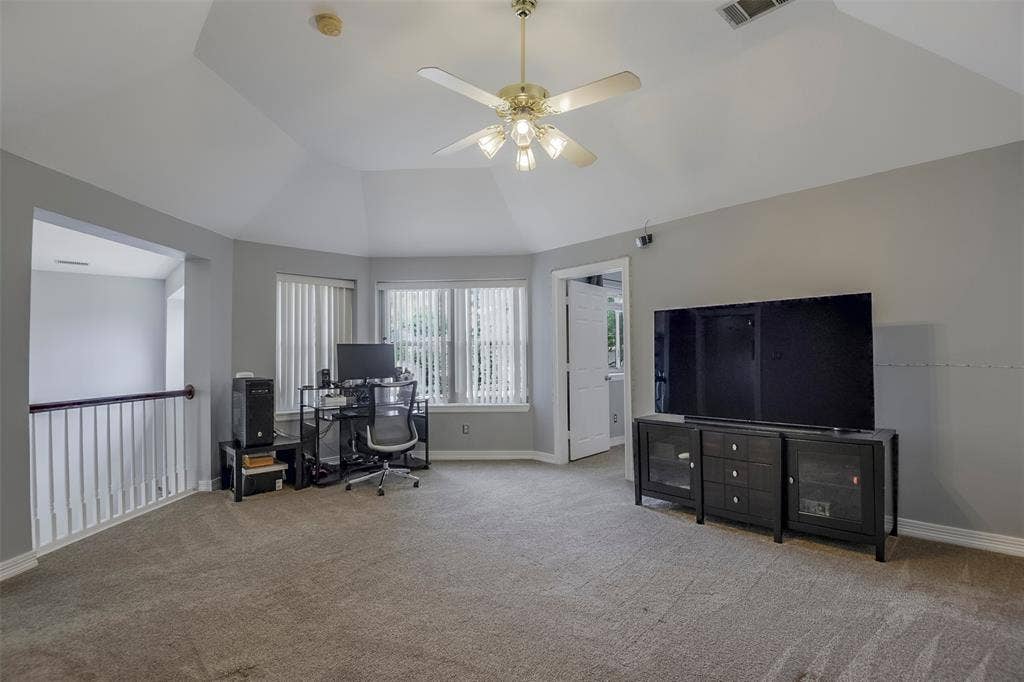 1200 Lakeway Drive, Plano, TX 75075 Carpeted room with vaulted ceiling and ceiling fan