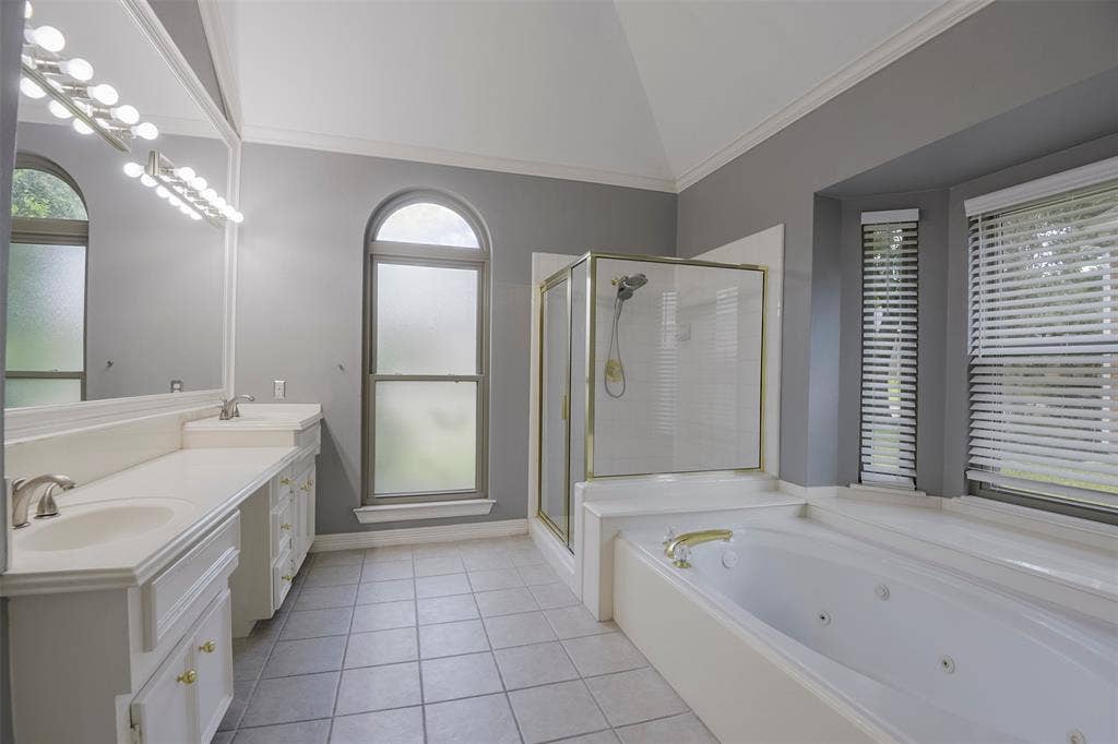 1200 Lakeway Drive, Plano, TX 75075 Vaulted ceiling, dual vanity, jetted soaking tub, glass-enclosed shower, and arched window