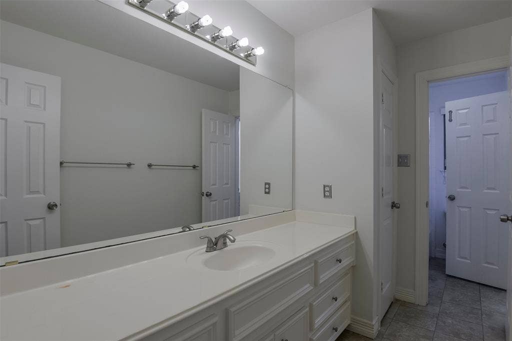 1200 Lakeway Drive, Plano, TX 75075 Vanity with an integrated sink, polished chrome faucet, and ample under-sink storage