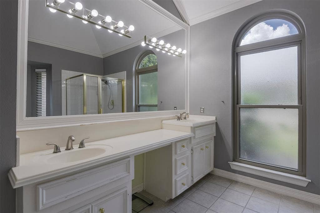 1200 Lakeway Drive, Plano, TX 75075 Dual vanity with integrated sinks, white cabinetry, and a large wall-mounted mirror