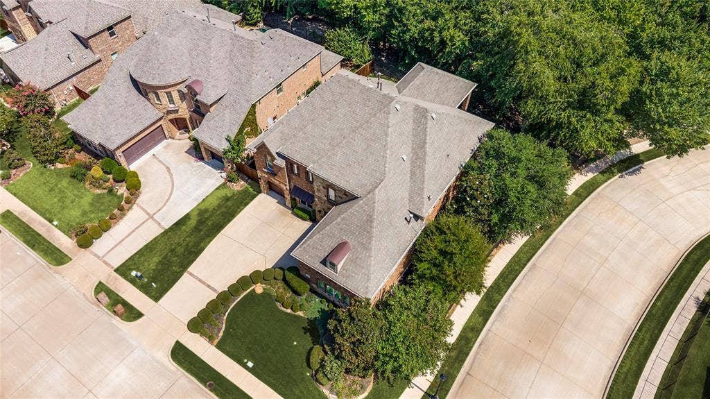 This home features custom landscaping and mature trees situated on a spacious corner lot; the community offers extensive walking and biking paths for residents.