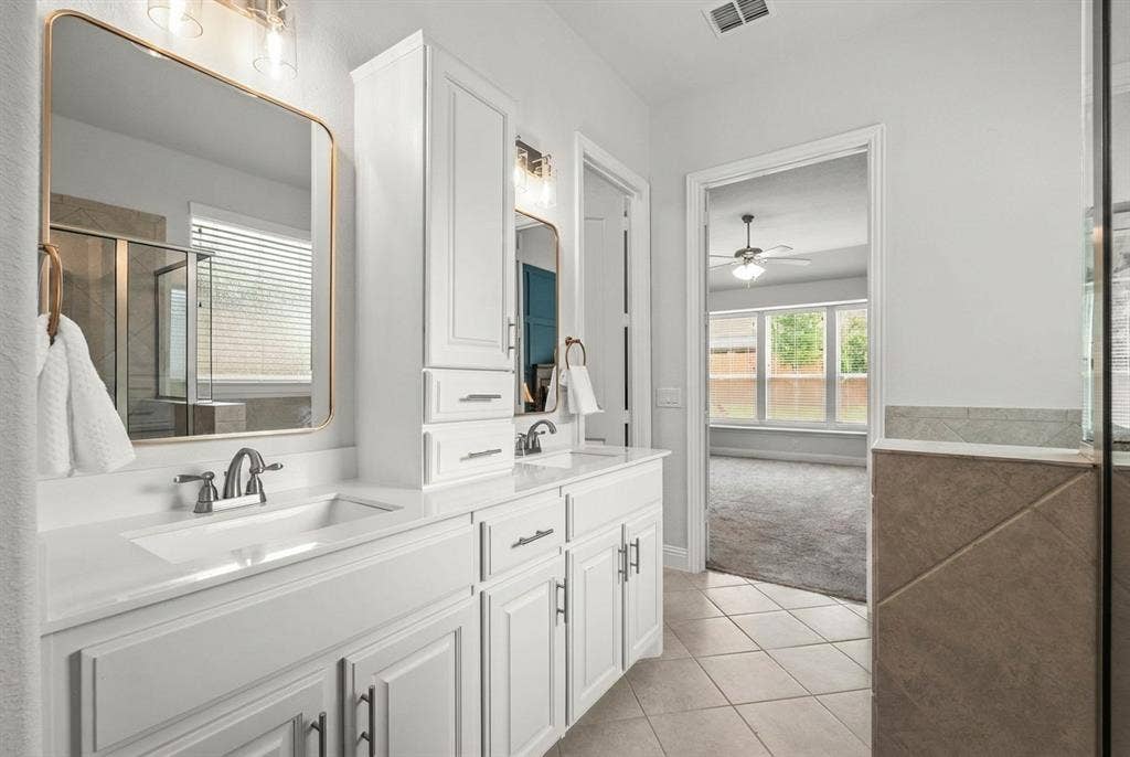 Primary Bath with quality built-in cabinets, separate shower, garden tub and large walk-in closet with built-in ironing table!