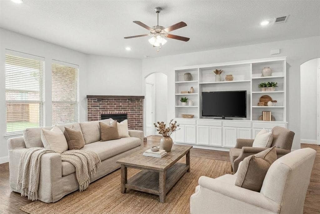 Quality built-in entertainment center with added storage and shelving. Cedar mantel accompanies the brick, gas fireplace.