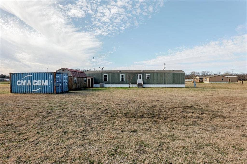 126 Starry Sky Court, Springtown, TX 76082 Expansive property featuring a single-story structure with green siding and white trim